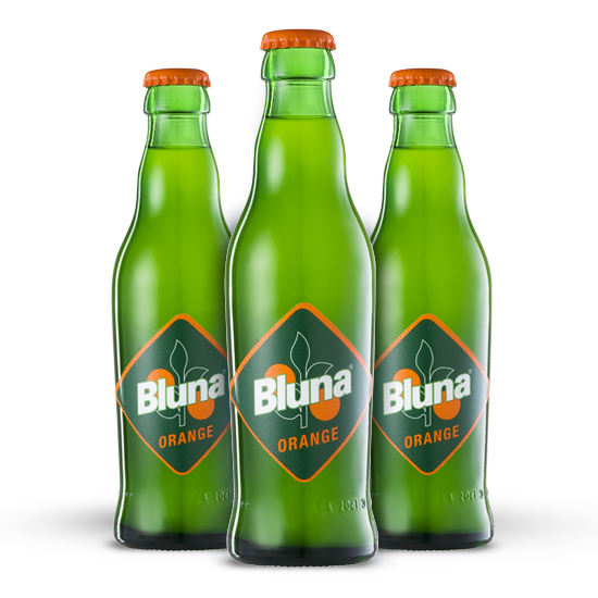 Three green Bluna bottles stand next to each other.